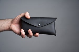 the loyal workshop tool pouch black being held in someone's hand