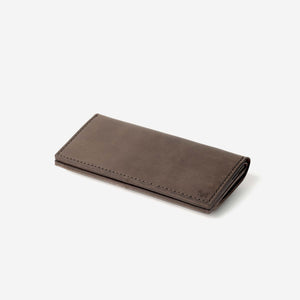 a dark brown leather wallet with hand stitching and etched logo details