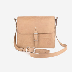 a natural tan leather satchel with hand stitched detailing, stainless steel hardware closures and a shoulder strap