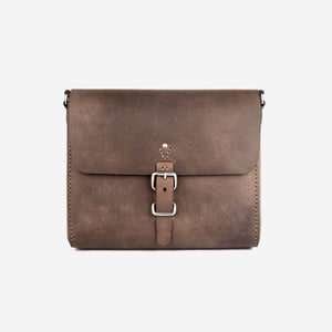 front view of a dark brown leather satchel with stainless steel hardware closure and hand stitched detailing