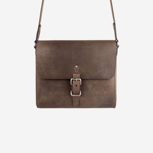 a dark brown leather satchel with shoulder strap, stainless steel hardware and hand stitched detailing