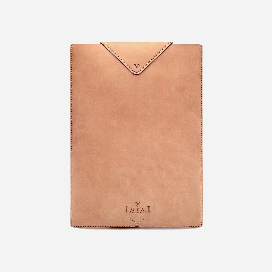 tan brown leather laptop sleeve with white stitch and etched logo detailing.