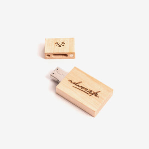A wooden USB stick with etched logo and writing on them